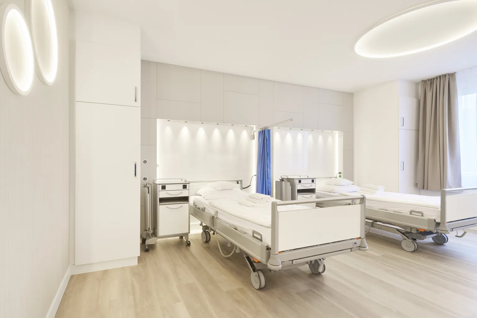 Im Hintergrund sieht man eine Versorgungswand aus einem Wahlleistungszimmer mit besonderen Lichtelementen